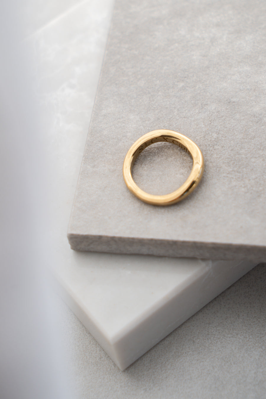 Gold ring on a gray surface